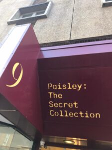 Purple sign that reads 'Paisley: the secret collection'