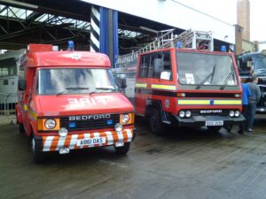 Two red fire engines from the mid-to-late 20th century.