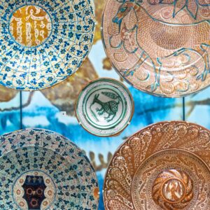 A display of richly decorated Iranian ceramic plates at the Burrell Collection.