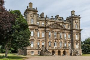 A four-storey stately home in a neo-classical style. It has ornately carved stone walls and long rows of tall windows.