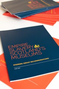 Copies of the Empire, Slavery & Scotland’s Museums Steering Group Recommendations arranged in a pile on a white surface.