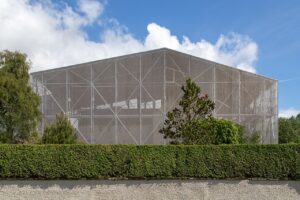 A house encased within a large metal structure.