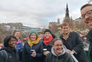 A group of MGS staff standing together in front of the Scott Monument in central Edinburgh.