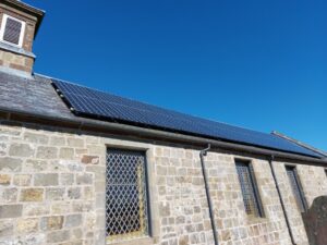Solar panels on the roof of a stone building