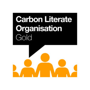 Outline of people with a black speech bubble above that reads 'Carbon Literate Organisation Gold.