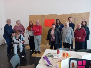 A small group of people gathered together and smiling at the camera.