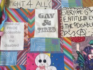 A colourful patchwork banner featuring images and slogans relating to LGBTQ+ and disabled rights.